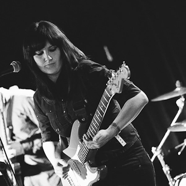 Cat playing bass live with her band